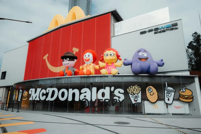 McDonald's restaurant facade with Ronald McDonald, Grimace, Birdie, and Hamburglar character inflatables