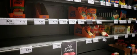 Grocery store shelves with price tags, illustrating the one-way ratchet of consumer prices