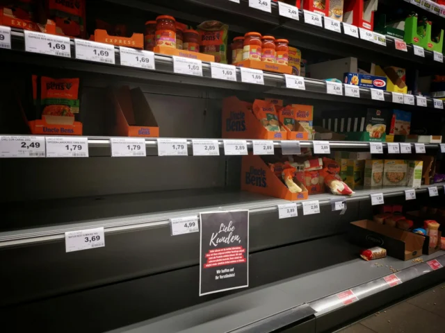 Grocery store shelves with price tags, illustrating the one-way ratchet of consumer prices
