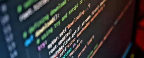 Frustrated developer debugging vibe coding errors at computer screen
