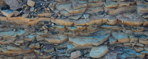 Sedimentary rock layers illustrating the geological fossil fuel formation process over millions of years