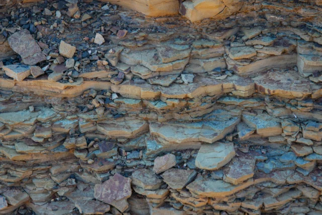 Sedimentary rock layers illustrating the geological fossil fuel formation process over millions of years