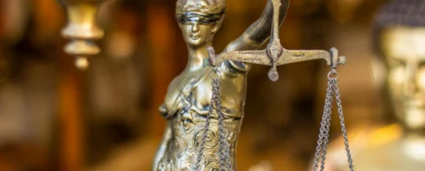 International law concept with scales of justice and global map symbolizing global legal system