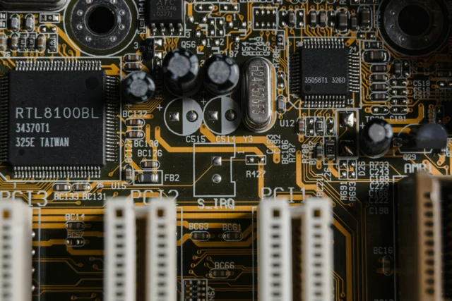 Close-up of a semiconductor chip on a circuit board, representing the global technology competition between the US and China