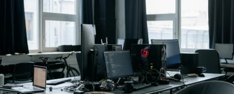 Junior developer working at computer with AI coding tools and uncertain job future