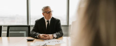 CFO discussing AI job cuts in boardroom meeting