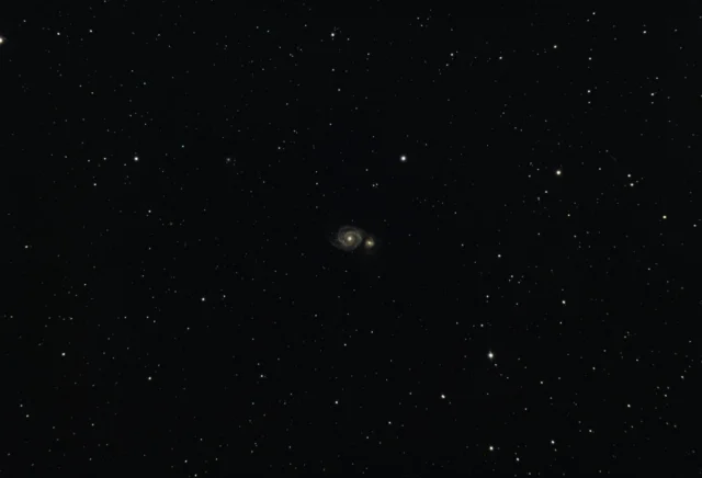 Galaxy cluster showcasing dark matter evidence through gravitational lensing effects