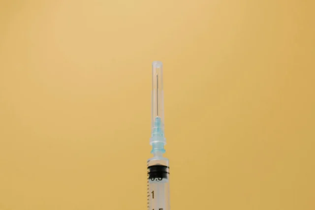 Syringe and vaccine vial representing the vaccine trust crisis in public health