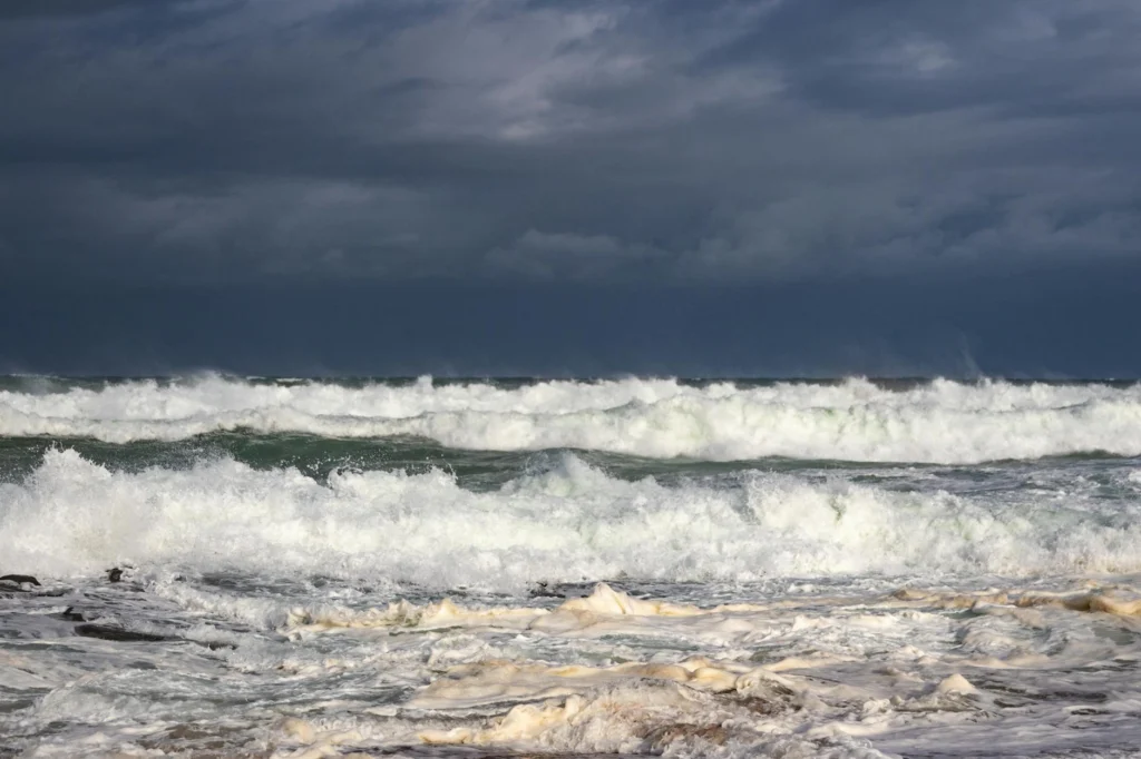 Waves crashing on the coast of Brest, Brittany, under grey skies