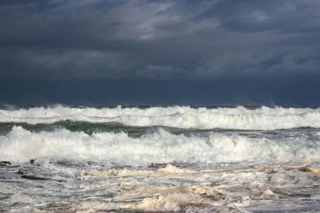 Waves crashing on the coast of Brest, Brittany, under grey skies