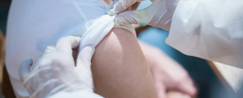 Medical professional administering shingles vaccine for heart protection study