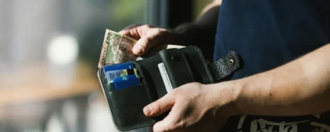 Consumer experiencing subscription fatigue while reviewing recurring charges