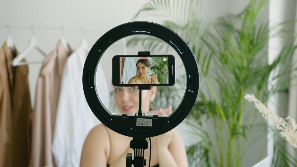Influencer authenticity performance captured as creator prepares content behind ring light