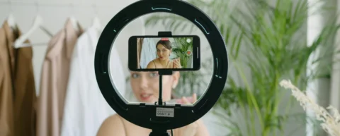 Influencer authenticity performance captured as creator prepares content behind ring light