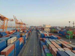 Shipping containers at port illustrating supply chain fragility in global logistics