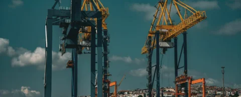 Port cranes symbolizing sovereign debt infrastructure losses in developing nations
