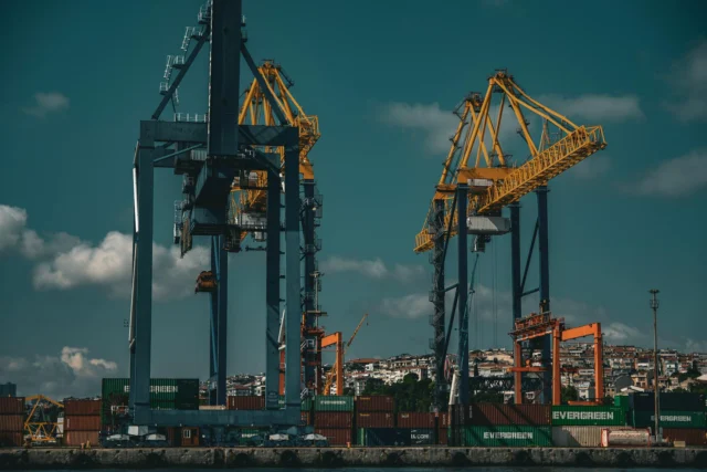 Port cranes symbolizing sovereign debt infrastructure losses in developing nations
