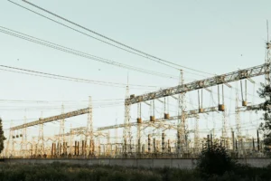 High-voltage electrical substation showing power grid infrastructure at dusk