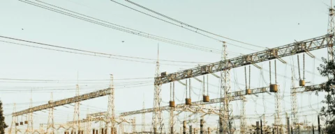 High-voltage electrical substation showing power grid infrastructure at dusk