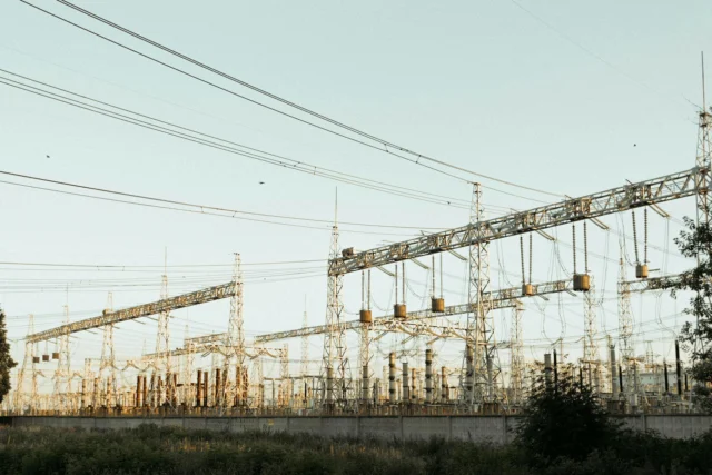 High-voltage electrical substation showing power grid infrastructure at dusk