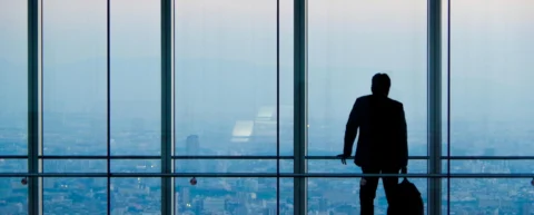 Lone figure in corporate hallway illustrating whistleblower retaliation psychology