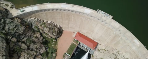 Hydroelectric dam with reservoir demonstrating renewable energy storage through gravitational potential
