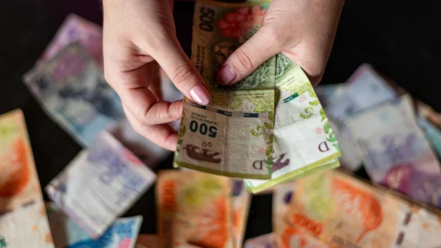 Cash in hand representing basic income experiments and unconditional payments