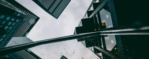 Glass office towers reflecting offshore tax havens financial district