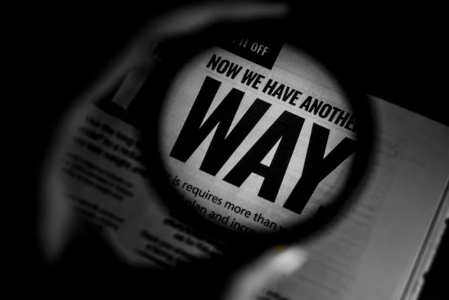 Magnifying glass over newspaper illustrating circular reporting investigation