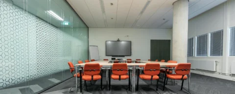 Empty corporate boardroom symbolizing trickle-down economics failure