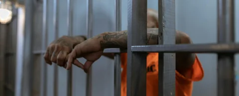 Prison bars casting shadows symbolizing the war on drugs failure
