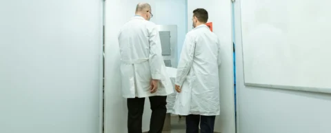 Forensic pathologist examining remains to determine postmortem interval