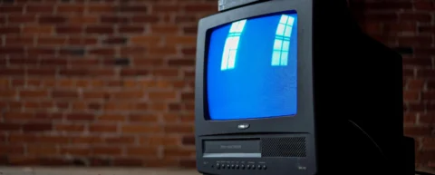 Television screen glowing in dark room illustrating true crime exploitation viewing habits