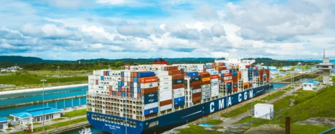 Container ship in narrow canal illustrating maritime infrastructure fragility