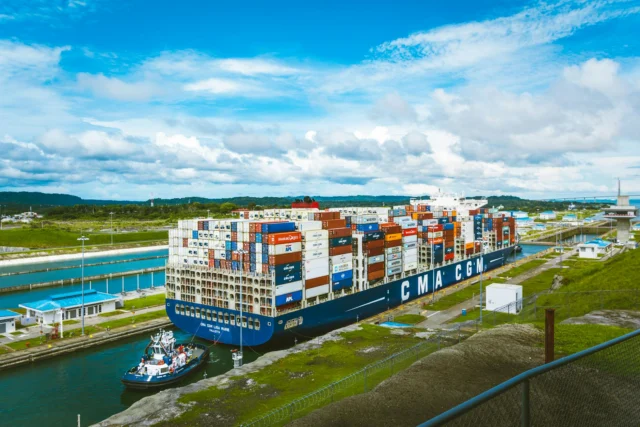 Container ship in narrow canal illustrating maritime infrastructure fragility