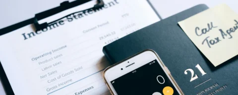 Financial ledger and movie clapperboard representing Hollywood accounting practices