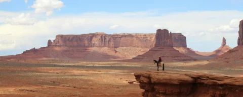 Desert landscape reminiscent of western genre mythology filmed in Monument Valley