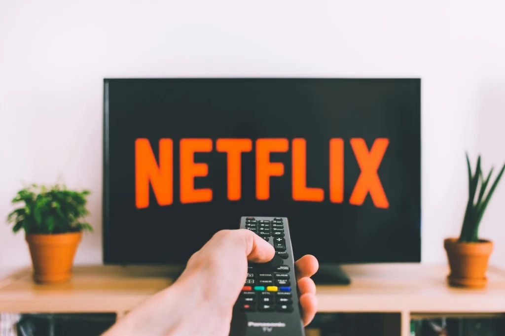 Multiple streaming service logos on a TV screen illustrating subscription fatigue streaming overload