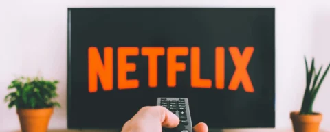 Multiple streaming service logos on a TV screen illustrating subscription fatigue streaming overload