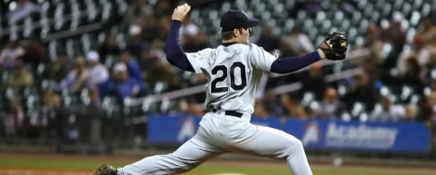 Baseball pitcher in mid-delivery demonstrating bullpen optimization mechanics