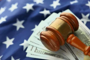 Courtroom gavel beside stacks of currency representing litigation funding as financial asset