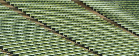 Empty stadium seats symbolizing college athletics realignment and consolidation