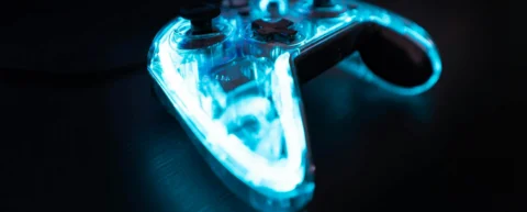Gaming controller with neon lighting representing V-Bucks digital currency ecosystem
