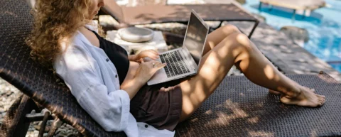 Laptop on beach resort table illustrating digital nomad visa tax lifestyle