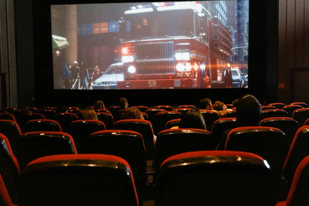 Audience experiencing disaster film psychology in darkened theater