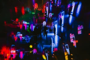 Massive festival crowd illuminated by neon lights, illustrating the scale of the festival-industrial complex