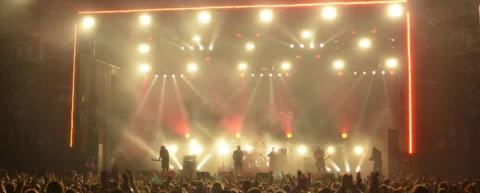 Rock concert crowd with stage lights illustrating performance based authenticity in modern pop music