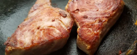 Steak searing in a pan demonstrating cooking heat chemistry and the Maillard reaction