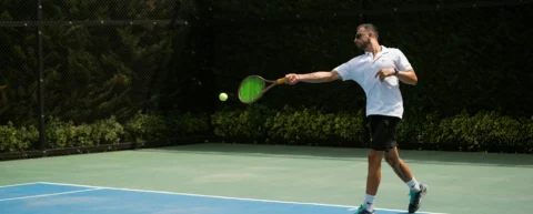Professional tennis player mid-backhand, illustrating tennis biomechanics analysis