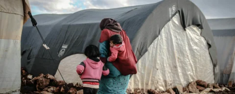 Refugees arriving in a host country, illustrating refugee resettlement economics